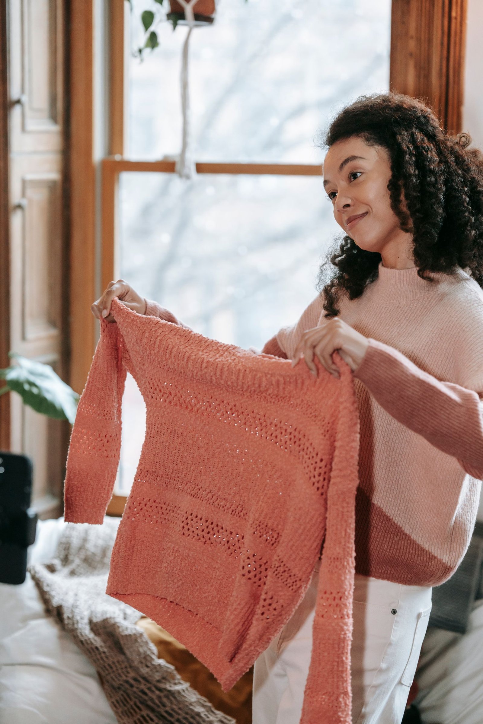 Spring quarter zip outfits - woman holding a knitted sweater